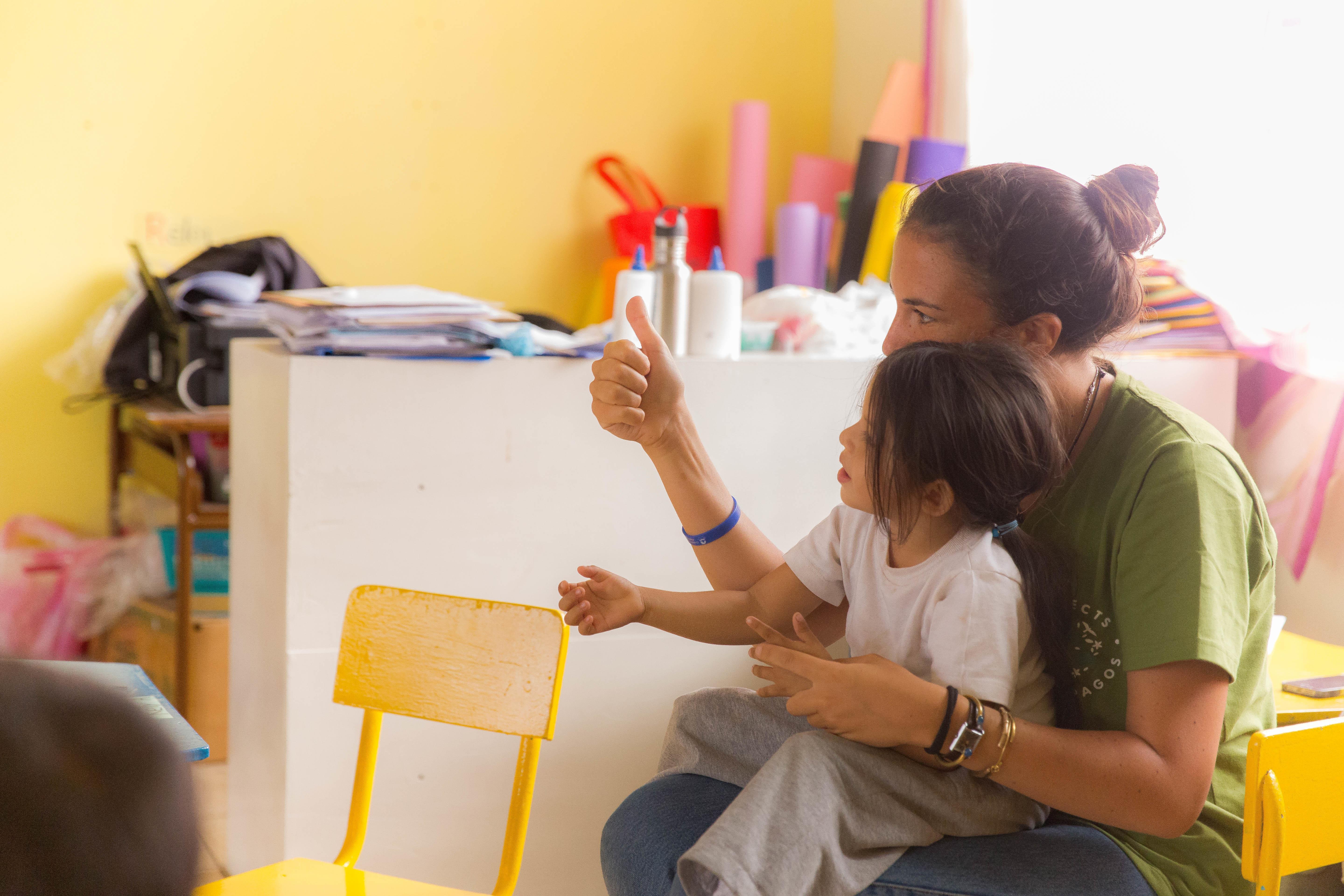 A Projects Abroad intern works with a child at her Social Work placement in Ecuador An intern working with a child and gaining social work experience in Ecuador